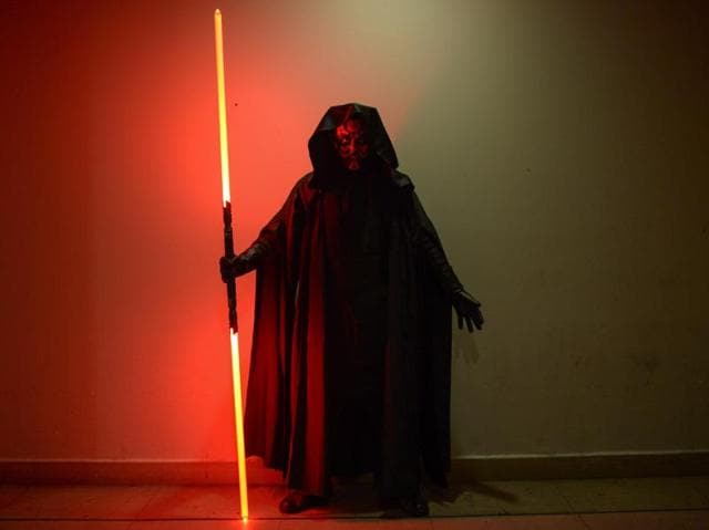 A member of Malaysia's Star Wars Fan Club (C) dressed as Darth Maul poses for pictures before watching Star Wars: The Force Awakens at a cinema in Subang, outside Kuala Lumpur on December 17. (AFP)