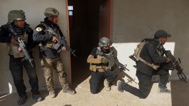 In this Sunday, Dec. 27, 2015 photo, Iraqi security forces search a building in the government complex in central Ramadi, 70 miles (115 kilometers) west of Baghdad, Iraq. (Osama Sami/AP Photo) In this Sunday, Dec. 27, 2015 photo, Iraqi security forces search a building in the government complex in central Ramadi, 70 miles (115 kilometers) west of Baghdad, Iraq. (Osama Sami/AP Photo)