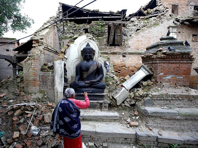 A woman offers daily prayers at the statue of Lord Buddha that was damaged during the earthquake in Bhaktapur of Nepal. (Reuters File Photo) A woman offers daily prayers at the statue of Lord Buddha that was damaged during the earthquake in Bhaktapur of Nepal. (Reuters File Photo)