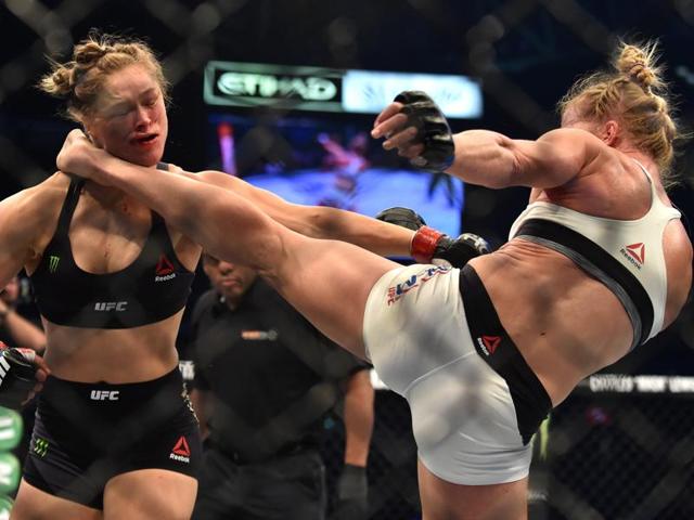 The knockout kick: Holly Holm of the US (R) delivers a kick to the neck to knock out compatriot Ronda Rousey and win the UFC 193 title fight. (AFP Photo) 