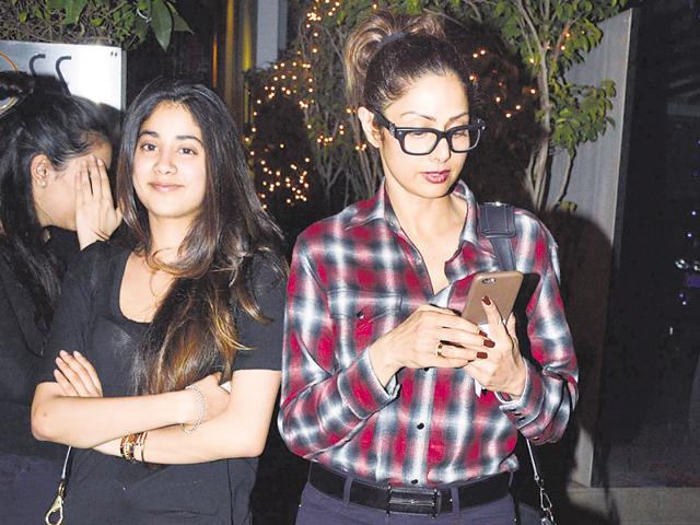 Reversing the roles? Sridevi is busy checking her phone even as her daughter Jhanvi Kapoor  smiles for the shutterbugs.  (Photo: Yogen Shah/HT) 