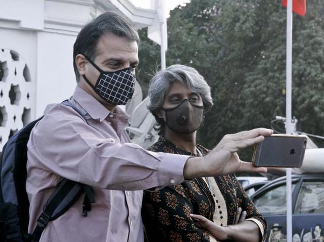 Delhi dialogue commission members take selfie wearing masks at the Delhi Assembly. (Sonu Mehta/ Hindustan Times)