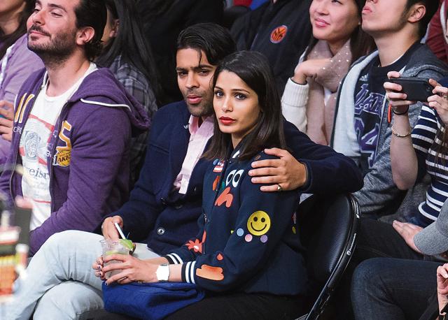 Freida Pinto and Ronnie Bacardi attend a basketball game between the Milwaukee Bucks and the Los Angeles Lakers at Staples Center on December 15, 2015 in Los Angeles, California. (GC Images)