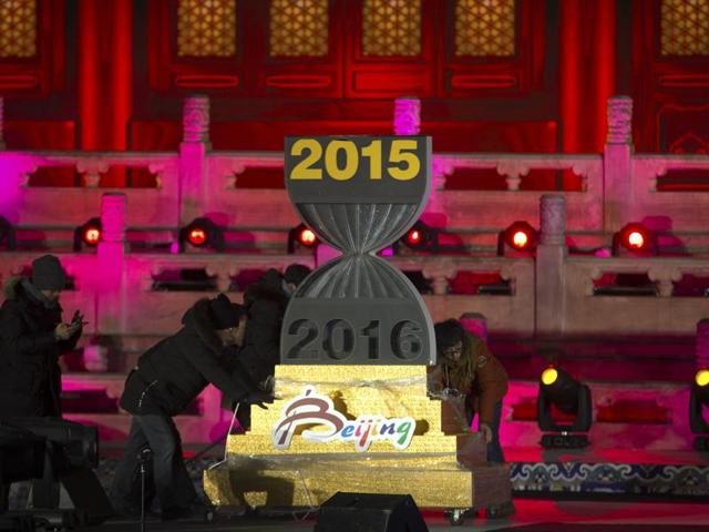 Workers push a 2016 countdown clock into position during a rehearsal for a New Year's Eve countdown celebration in Beijing. As the world gears up for a new year, security agencies across the world have sent out terror alerts in major cities from Europe to China.(AP)