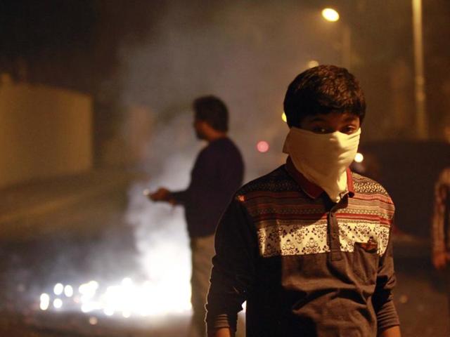 A boy wearing a mask to protect himself against air pollution as fire crackers add to the smog and air pollution on Diwali (Deepawali) in New Delhi. (Arvind Yadav/ Hindustan Times)
