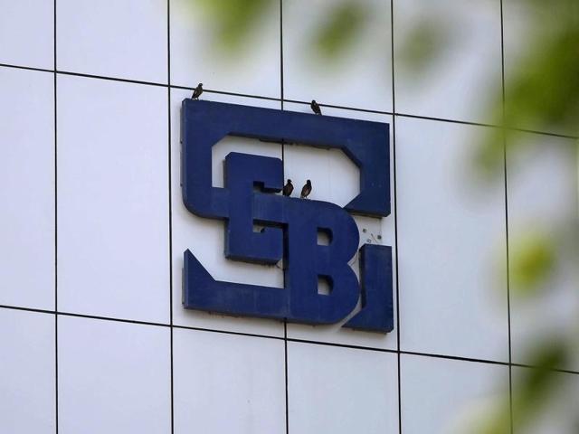 Birds rest on the logo of the Securities and Exchange Board of India (SEBI), India's market regulator, installed on the facade of its head office building in Mumbai. (REUTERS) Birds rest on the logo of the Securities and Exchange Board of India (SEBI), India's market regulator, installed on the facade of its head office building in Mumbai. (REUTERS)