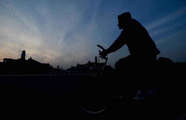 A man pedals his cycle as Raisina Hill is silhouetted during the last sunset of 2015 in New Delhi on Thursday. (PTI) A man pedals his cycle as Raisina Hill is silhouetted during the last sunset of 2015 in New Delhi on Thursday. (PTI)