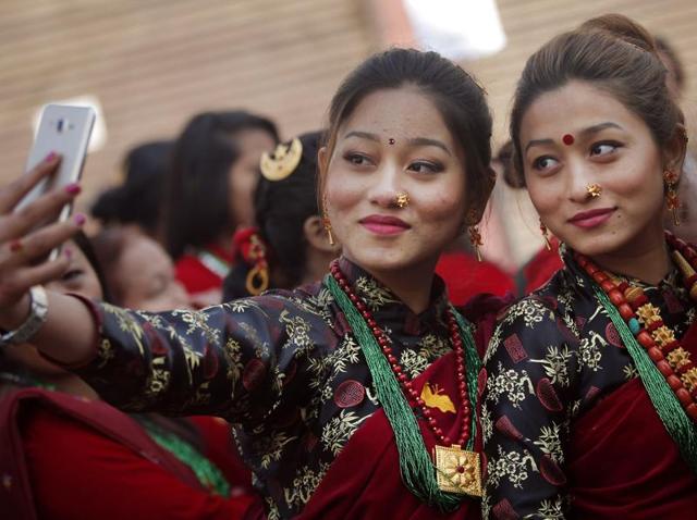 Nepalese Gurung community women wearing traditional attire take their selfie at a parade to mark their New Year known as "Tamu Loshar" in Kathmandu. The indigenous Gurungs, also known as Tamu, are celebrating the advent of the year of the monkey. (AP Photo/Niranjan Shrestha)