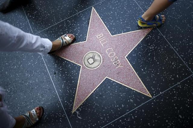 People walk over Bill Cosby's star of the Hollywood Walk of Fame in Los Angeles, California, United States July 9, 2015. (Reuters)