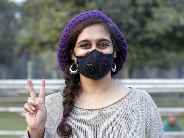 A girl poses for a photo while attending the campaign against pollution at India Gate. (Ravi Choudhary/ Hindustan Times)