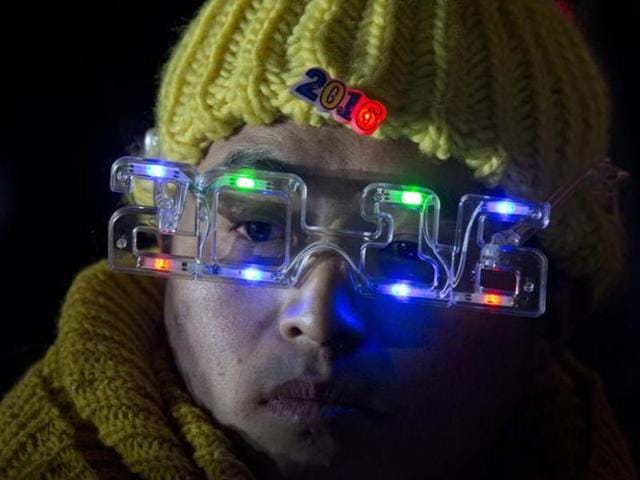 A worker wears mock spectacles in the shape of 2016 during a countdown event in Beijing. (AP Photo) A worker wears mock spectacles in the shape of 2016 during a countdown event in Beijing. (AP Photo)