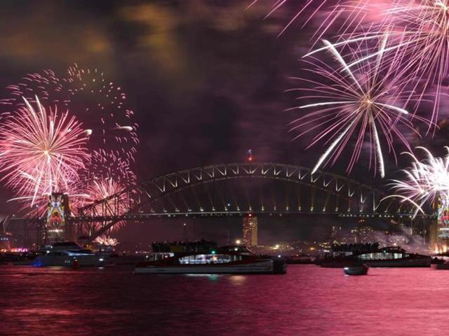 New Year’s Eve fireworks illuminate Sydney’s iconic Harbour Bridge during the traditional early family fireworks show held before the main midnight event on December 31. (AFP Photo) New Year’s Eve fireworks illuminate Sydney’s iconic Harbour Bridge during the traditional early family fireworks show held before the main midnight event on December 31. (AFP Photo)
