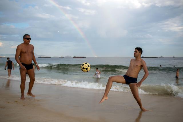 People play football in Copacabana beach during last day of the year in Rio de Janeiro. (AP) People play football in Copacabana beach during last day of the year in Rio de Janeiro. (AP)