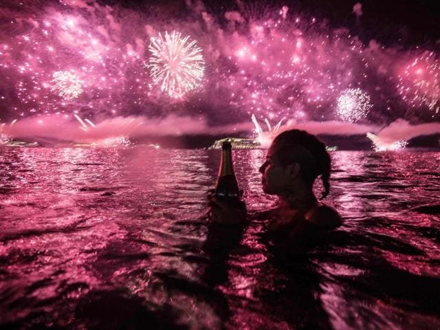 A woman watches fireworks just after New Years at Copacabana beach in Rio de Janeiro. (AFP Photo) A woman watches fireworks just after New Years at Copacabana beach in Rio de Janeiro. (AFP Photo)