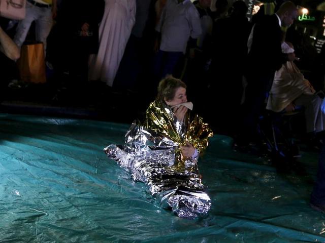 A wounded woman cries outside the Address Downtown Dubai hotel and residential block after a fire engulfed the skyscraper in downtown Dubai in the United Arab Emirates. (REUTERS) 