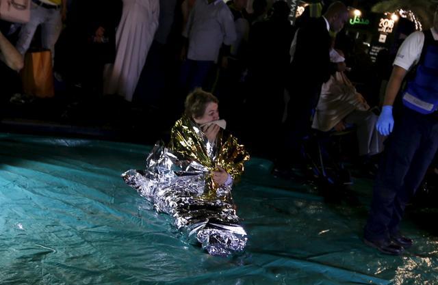 A wounded woman cries outside the Address Downtown Dubai hotel and residential block after a fire engulfed the skyscraper in downtown Dubai. (Reuters Photo) A wounded woman cries outside the Address Downtown Dubai hotel and residential block after a fire engulfed the skyscraper in downtown Dubai. (Reuters Photo)