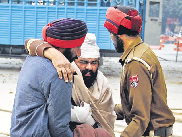 With no wheelchair available, cops had to pick up the accused Jagmohan Singh, who was produced before a magistrate in Jalandhar. (HT Photo) With no wheelchair available, cops had to pick up the accused Jagmohan Singh, who was produced before a magistrate in Jalandhar. (HT Photo)