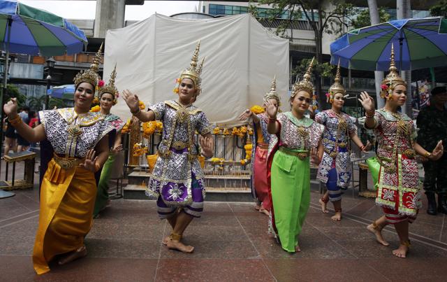 In this Sept. 1, 2015 file photo, Thai classical dancers perform in front of Phra Phrom, the Thai interpretation of the Hindu god Brahma, at the Erawan Shrine in Bangkok, Thailand. (AP Photo) In this Sept. 1, 2015 file photo, Thai classical dancers perform in front of Phra Phrom, the Thai interpretation of the Hindu god Brahma, at the Erawan Shrine in Bangkok, Thailand. (AP Photo)