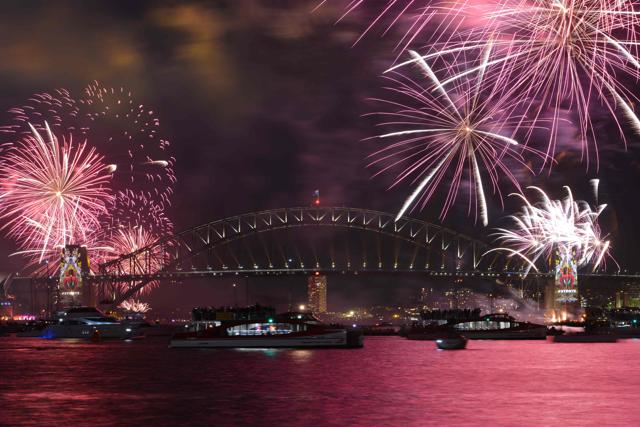 New Year's Eve fireworks illuminate Sydney's iconic Harbour Bridge during the traditional early family fireworks show held before the main midnight event on December 31. (AFP) New Year's Eve fireworks illuminate Sydney's iconic Harbour Bridge during the traditional early family fireworks show held before the main midnight event on December 31. (AFP)