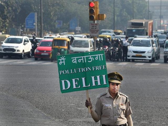 A civil defence volunteer holds a placard during a trial run of the odd-even car scheme at ITO in New Delhi. (PTI) A civil defence volunteer holds a placard during a trial run of the odd-even car scheme at ITO in New Delhi. (PTI)