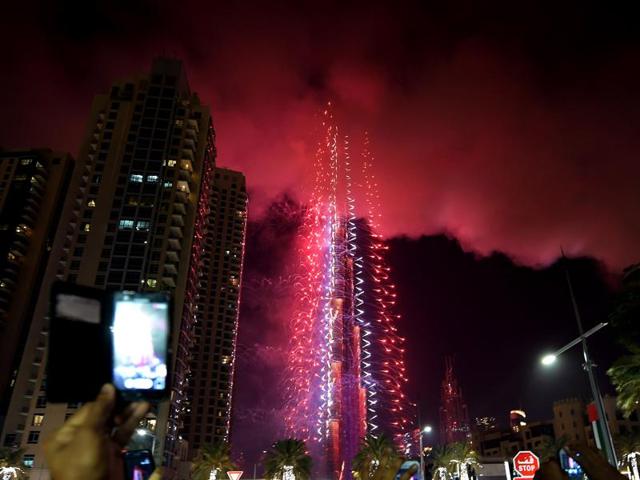 A spectacular fireworks display kicked off as planned at midnight (2000 GMT), beginning at the 828 metre (2,700 foot) high Burj Khalifa before spread across the skies of the cash-flush city above thousands of cheering spectators. (AFP) 