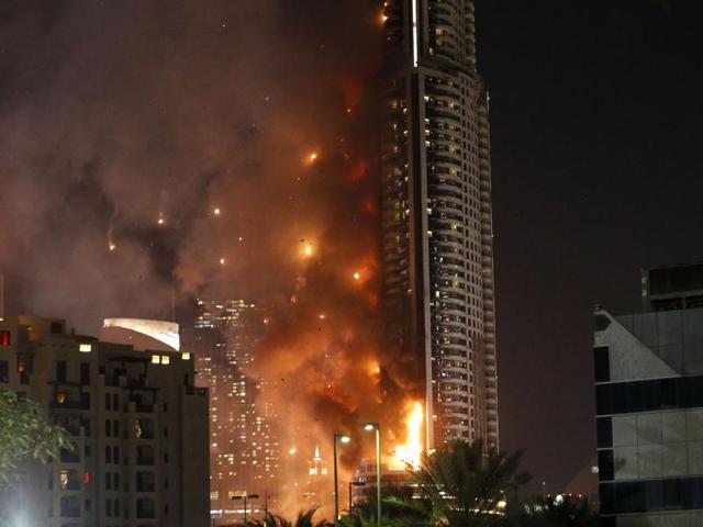 Smoke billows from the Address Downtown Hotel, after it caught on fire hours earlier, past fireworks, near the Burj Khalifa. (AFP) Smoke billows from the Address Downtown Hotel, after it caught on fire hours earlier, past fireworks, near the Burj Khalifa. (AFP)
