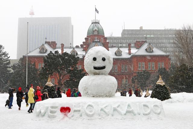 Children play around a snowman in front of the former Hokkaido Government Office in Sapporo, Japan. It was used for approximately 80 years until the new government office currently in use was built. (Shutterstock)