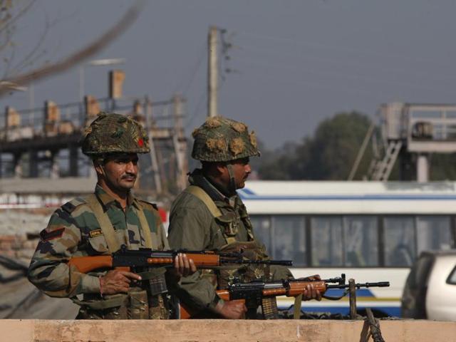 Soldiers take positions outside the Indian airbase in Pathankot that came under attack.(AP)