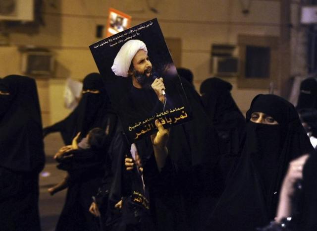 A protester holds up a picture of Sheikh Nimr al-Nimr during a rally at the coastal town of Qatif, against Sheikh Nimr's arrest on July 8, 2012. (Reuters File) A protester holds up a picture of Sheikh Nimr al-Nimr during a rally at the coastal town of Qatif, against Sheikh Nimr's arrest on July 8, 2012. (Reuters File)