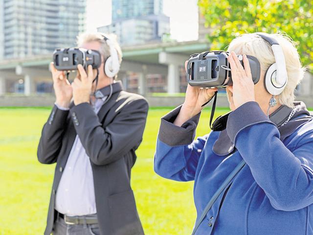 Visitors experience the Time Tablet during a preview at the Fort York National Historic Site.