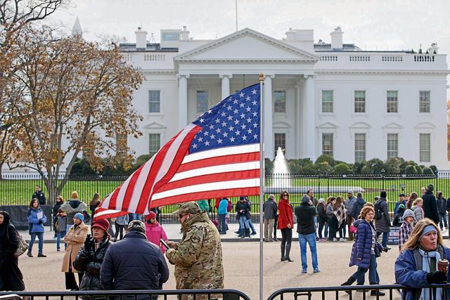 In this November 27 (2014) file photo, people gather along Pennsylvania Avenue outside the White House in Washington. (AP Photo/J. Scott Applewhite, File) In this November 27 (2014) file photo, people gather along Pennsylvania Avenue outside the White House in Washington. (AP Photo/J. Scott Applewhite, File)