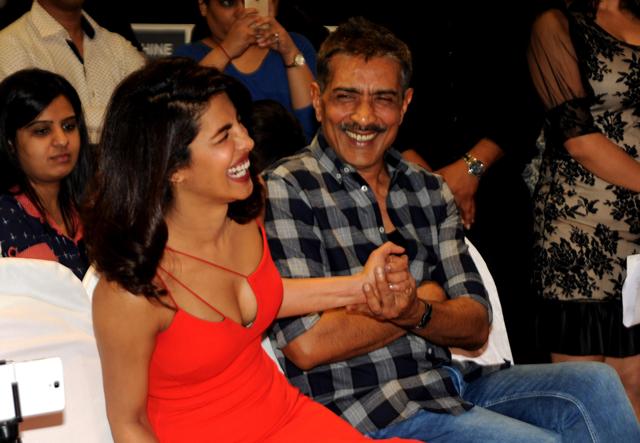 Prakash Jha (R) and Priyanka Chopra share a light moment during a promotional event for Jha's forthcoming film Jai Gangaajal in Mumbai. (AFP)