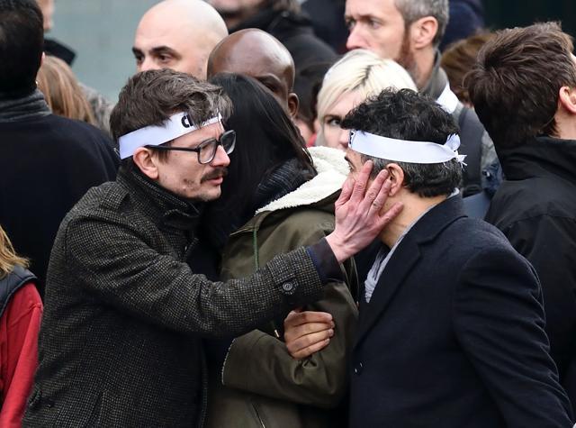 This file photo taken on January 11, 2015 shows Renald Luzier, known as Luz (L) with editorialist Dr Patrick Pelloux as the Charlie Hebdo satirical magazine team takes part in a Unity rally "Marche Republicaine" in Paris. (AFP)