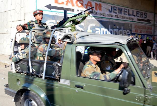 Indian army vehicle passes by a checkpost following fresh firing and explosions inside the air base, in Pathankot on Sunday. (Sameer Sehgal/ Hindustan Times)