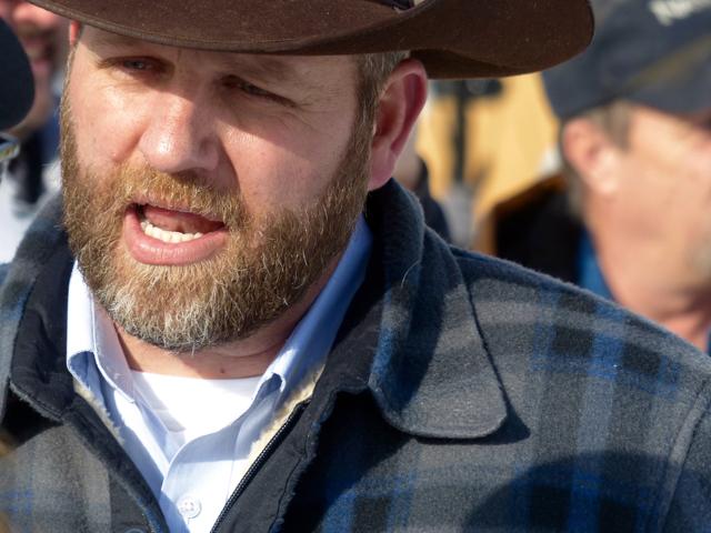 Ammon Bundy chats with a protester Saturday, during a march on behalf of a Harney County ranching family in Burns, Ore. Bundy, the son of Nevada rancher Cliven Bundy, who was involved in a standoff with the government over grazing rights, told local press that he and two of his brothers were among a group of dozens of people occupying the headquarters of the Malheur National Wildlife Refuge. (AP Photo) Ammon Bundy chats with a protester Saturday, during a march on behalf of a Harney County ranching family in Burns, Ore. Bundy, the son of Nevada rancher Cliven Bundy, who was involved in a standoff with the government over grazing rights, told local press that he and two of his brothers were among a group of dozens of people occupying the headquarters of the Malheur National Wildlife Refuge. (AP Photo)