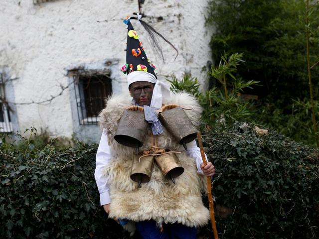 A man dressed in sheepskins with jingling bells to make noise, and so-called Zamarraco (warriors of the good), poses for a photograph during the Vijanera festival, in the small village of Silio, northern Spain, Sunday, January 3, 2016. The Vijanera masquerade, of pre-Roman origin, is the first carnival of the year in Europe symbolising the triumph of good over evil and involving the participation of crowds of residents wearing different masks, animal skins and brightly coloured clothing with its own complex function and symbolism and becoming the living example of the survival of archaic cults to nature. (AP) A man dressed in sheepskins with jingling bells to make noise, and so-called Zamarraco (warriors of the good), poses for a photograph during the Vijanera festival, in the small village of Silio, northern Spain, Sunday, January 3, 2016. The Vijanera masquerade, of pre-Roman origin, is the first carnival of the year in Europe symbolising the triumph of good over evil and involving the participation of crowds of residents wearing different masks, animal skins and brightly coloured clothing with its own complex function and symbolism and becoming the living example of the survival of archaic cults to nature. (AP)