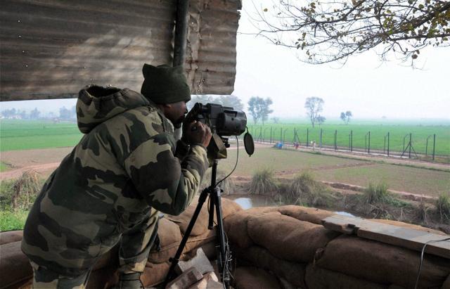A Border Security Force (BSF) soldier keeps a watch at the border fence at Bamial border in Pathankot on Monday. (PTI) A Border Security Force (BSF) soldier keeps a watch at the border fence at Bamial border in Pathankot on Monday. (PTI)