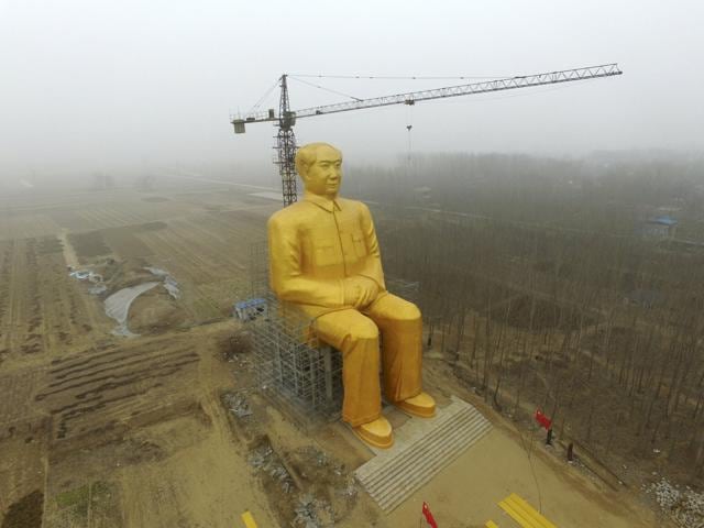 A crane is seen next to a giant statue of Chinese late chairman Mao Zedong. (REUTERS) A crane is seen next to a giant statue of Chinese late chairman Mao Zedong. (REUTERS)