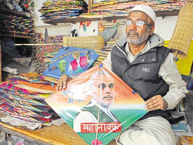 Talib shows a kite with Prime Minister Narendra Modi’s picture on it at his shop in Ranchi. (HT Photo) Talib shows a kite with Prime Minister Narendra Modi’s picture on it at his shop in Ranchi. (HT Photo)