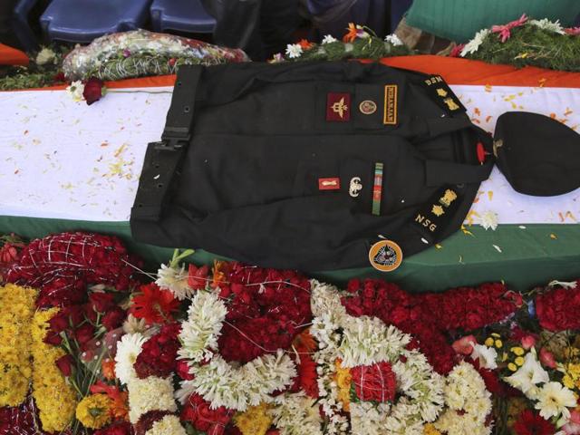 The uniform of National Security Guard commando Niranjan Kumar, who was among those killed in the attack on the Pathankot air force base is placed on his coffin draped in an Indian flag, in Bangalore. (AP)