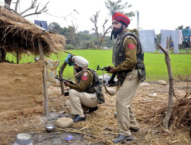 Punjab Police officers conduct a search operation at Manwal village in Pathankot during anti-terrorist operations on Monday. Punjab Police officers conduct a search operation at Manwal village in Pathankot during anti-terrorist operations on Monday.