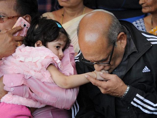 Father and daughter of Lt Col Niranjan Kumar during his funeral in his home town in Bengaluru. (PTI)