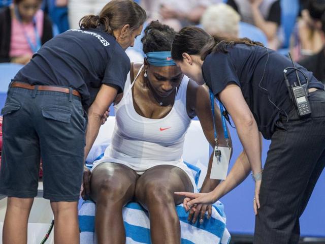 Serena Williams speaks to medical staff before withdrawing from the Hopman Cup in Perth.(Reuters Photo)