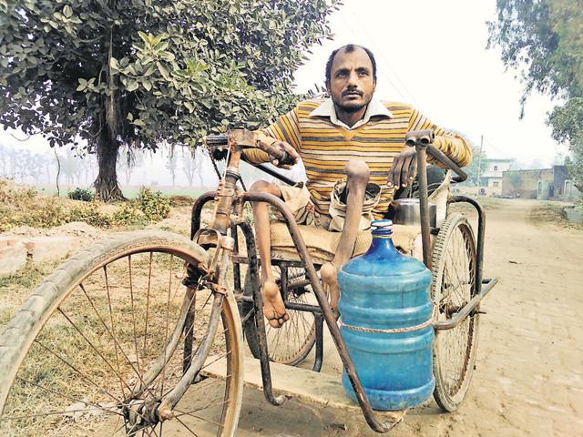Basant Singh, a resident of Devi Wala village of Faridkot district, who has almost 100 per cent physical inability as both of his legs were left badly crippled by the polio in childhood.(HT Photo)