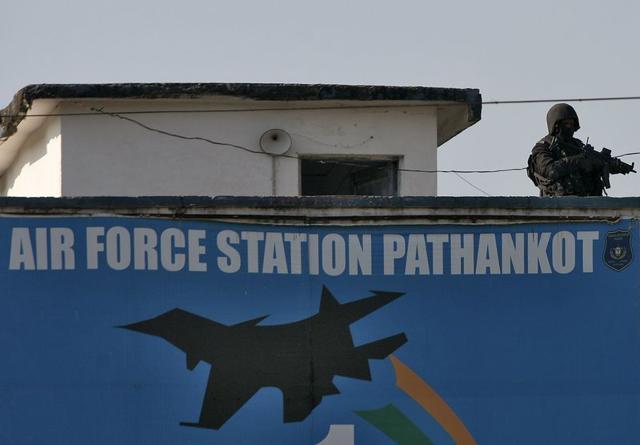 An Indian security personnel stands guard on a building at the Indian Air Force (IAF) base at Pathankot in Punjab. (REUTERS) An Indian security personnel stands guard on a building at the Indian Air Force (IAF) base at Pathankot in Punjab. (REUTERS)