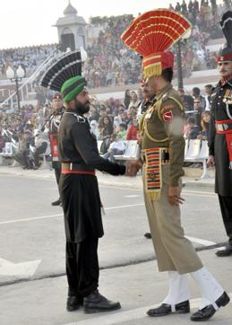 Singh greeting a member of the Indian Armed Forces at Wagah. (ANI Photo)