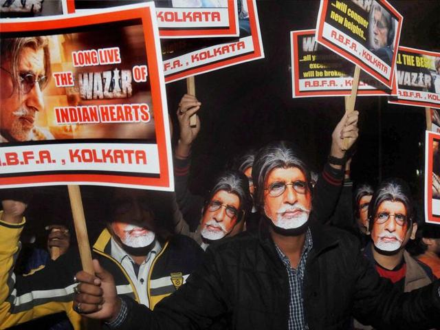 Fans of Amitabh Bachchan wearing his masks to celebrate during the special screening of Wazir in Kolkata on Thursday. (PTI) 