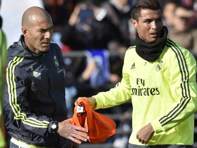 Real Madrid's new coach Zinedine Zidane and forward Cristiano Ronaldo gesture during his first training session. (AFP Photo) Real Madrid's new coach Zinedine Zidane and forward Cristiano Ronaldo gesture during his first training session. (AFP Photo)