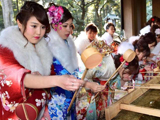 20-year-old female tour guides dressed in traditional kimonos during a ‘purification ceremony’ with a Shinto priest at Tokyo's Meiji shrine to celebrate Japan's Coming-of-Age Day on Friday. (AFP) 20-year-old female tour guides dressed in traditional kimonos during a ‘purification ceremony’ with a Shinto priest at Tokyo's Meiji shrine to celebrate Japan's Coming-of-Age Day on Friday. (AFP)