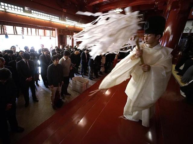 A Shinto priest blesses businessmen for the prosperity of their firms during a ceremony at Kanda Myojin Shrine in Tokyo, on the first business day of the year in Tokyo, Monday, January 4. (AP) A Shinto priest blesses businessmen for the prosperity of their firms during a ceremony at Kanda Myojin Shrine in Tokyo, on the first business day of the year in Tokyo, Monday, January 4. (AP)
